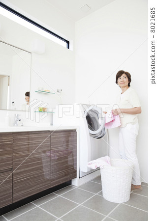 Woman doing the laundry Woman doing the laundry 8021685