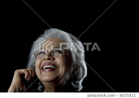 Old woman talking on a mobile phone Old woman talking on a mobile phone 8025811