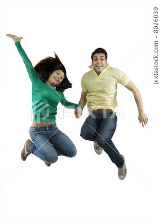 Boy and girl jumping in the air Boy and girl jumping in the air 8026039