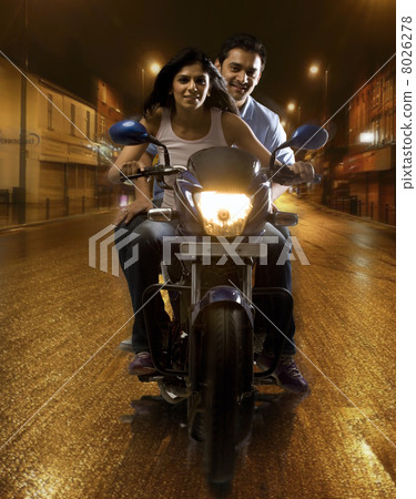 Couple on a motorbike Couple on a motorbike 8026278