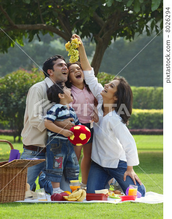 Family enjoying themselves at a picnic Family enjoying themselves at a picnic 8026294
