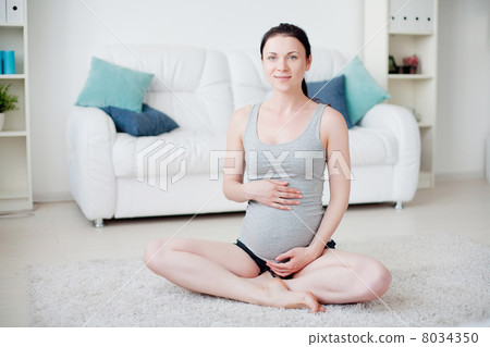 Young pregnant woman do yoga indoors 8034350