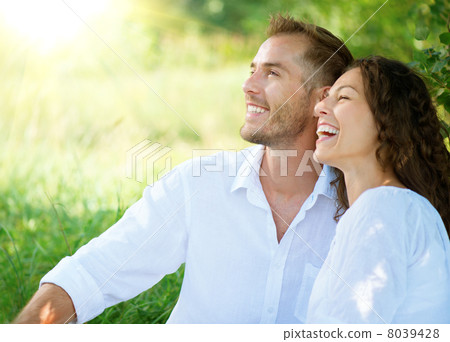 Happy Smiling Couple Relaxing in a Park Happy Smiling Couple Relaxing in a Park 8039428