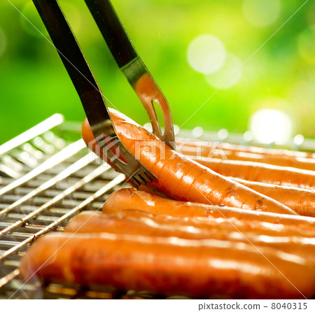 Grilled Sausage on the flaming Grill. BBQ. Bearbeque outdoors Grilled Sausage on the flaming Grill. BBQ. Bearbeque outdoors 8040315