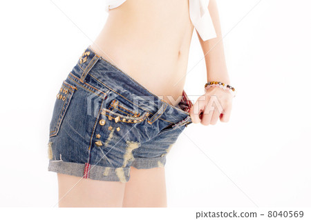 A woman wearing a shorts of jeans who succeeded in dieting and became loose A woman wearing a shorts of jeans who succeeded in dieting and became loose 8040569