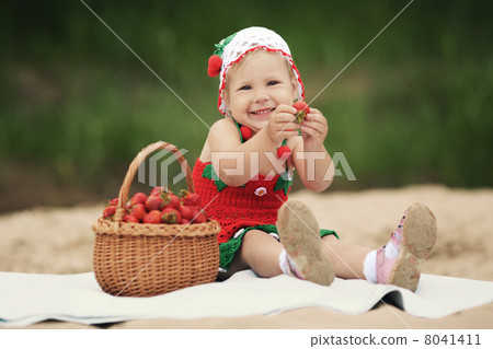 little girl with basket full of strawberries 8041411