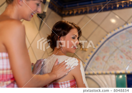 Two female friends in the sauna of a thermal bath 8048834