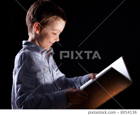 Boy opened a magic book 8054136
