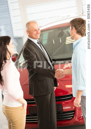 Couple buying a car in dealership 8065486