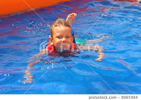 Enthusiastic kid in vest at the pool water park 8065984