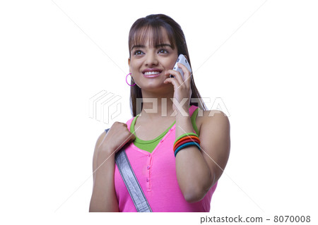 Beautiful young woman using mobile phone over white background Beautiful young woman using mobile phone over white background 8070008