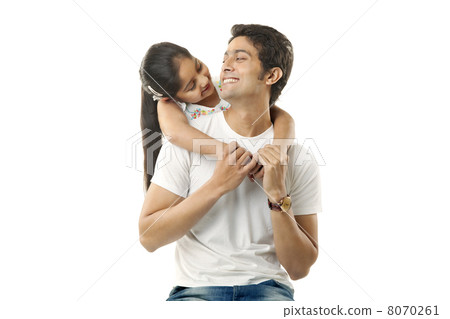 Girl wrapping her arms around her fathers neck Girl wrapping her arms around her fathers neck 8070261