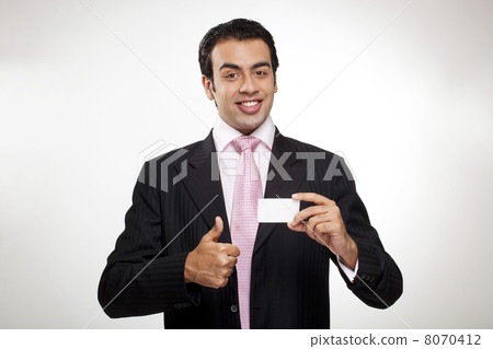 Businessman giving a thumbs up 8070412