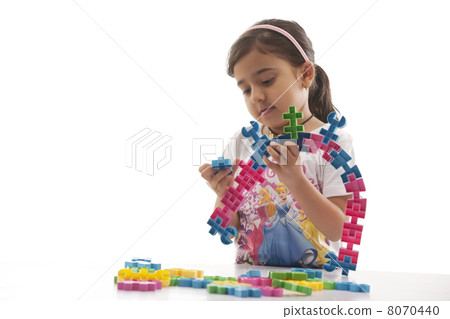 Girl playing with building blocks 8070440