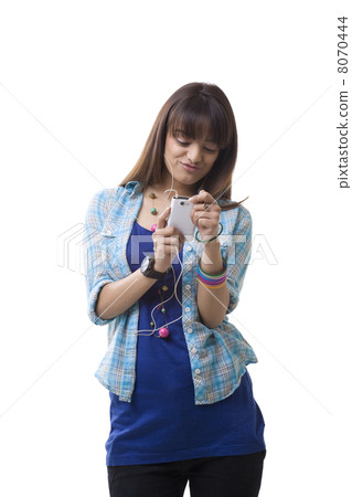 Young woman listening to MP3 player over white background 8070444
