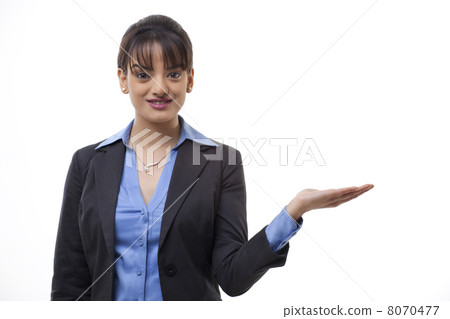 Portrait of beautiful young business woman presenting over white background 8070477