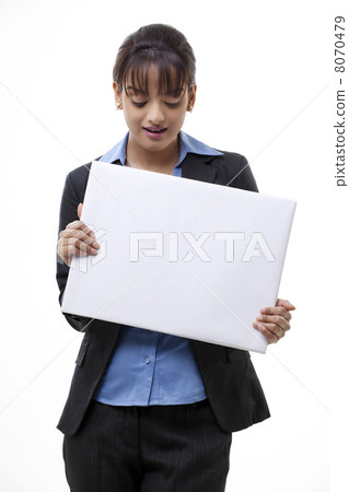 Portrait of businesswoman holding blank card over white background 8070479