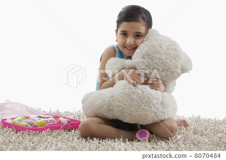 Girl hugging her teddy bear 8070484
