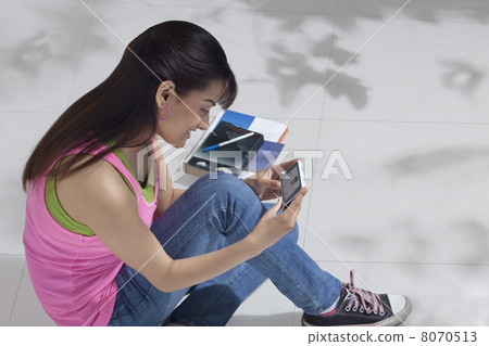 High angle view of happy female college student using cell phone 8070513