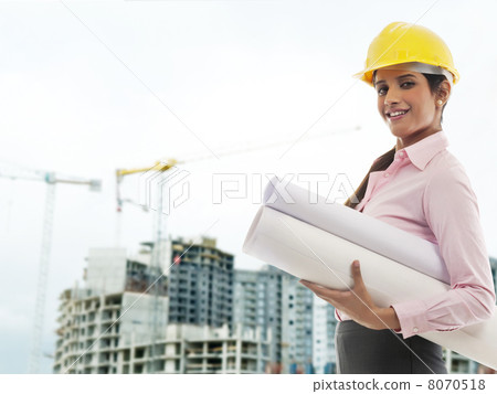 Female engineer with blueprints Female engineer with blueprints 8070518