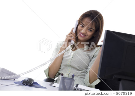 Happy young business woman using telephone at office Happy young business woman using telephone at office 8070519
