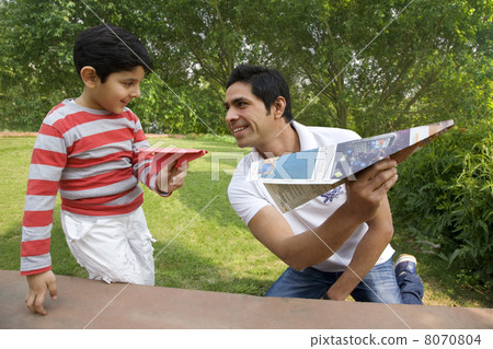 Father and son having fun with paper airplanes 8070804