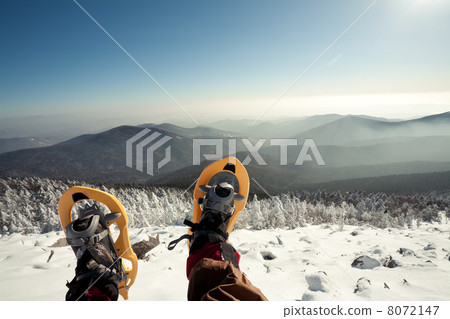 Hiker in winter mountains snowshoeing 8072147