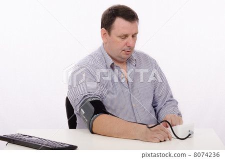 A middle aged man with tonometer 8074236