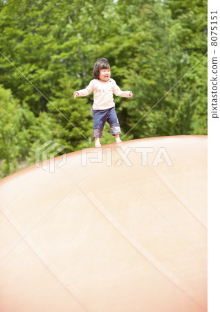 Girl playing with play equipment 8075151
