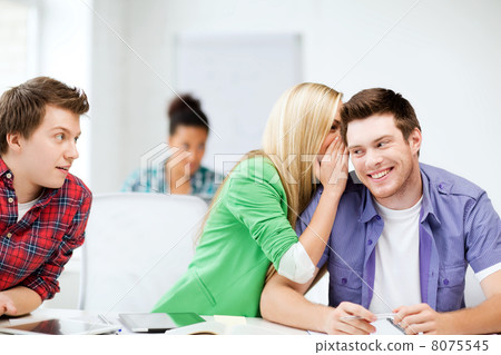 group of students gossiping at school group of students gossiping at school 8075545