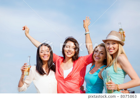 girls with drinks on the beach 8075863