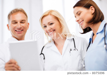 doctors looking at tablet pc 8075896