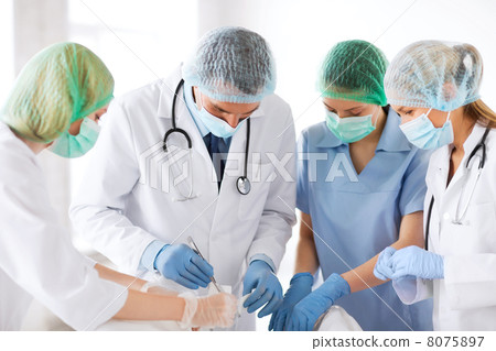 young group of doctors doing operation 8075897