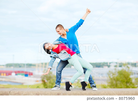 couple of teenagers dancing outside 8075960