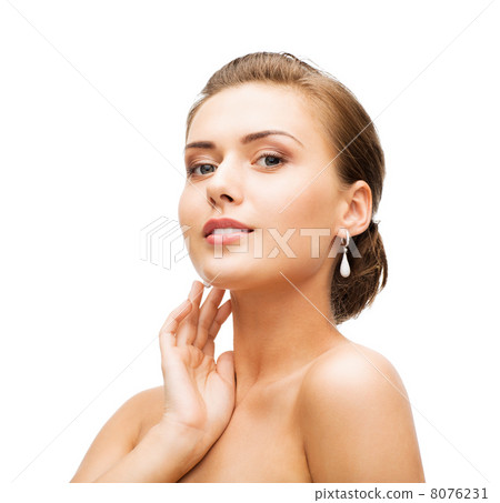 woman wearing shiny diamond earrings 8076231