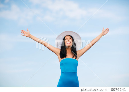 girl with hands up on the beach 8076241