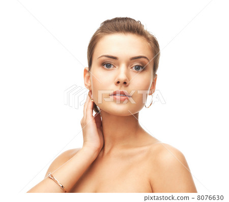 woman wearing gold earrings and bracelet 8076630