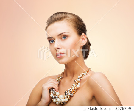woman wearing pearl statement necklace 8076709