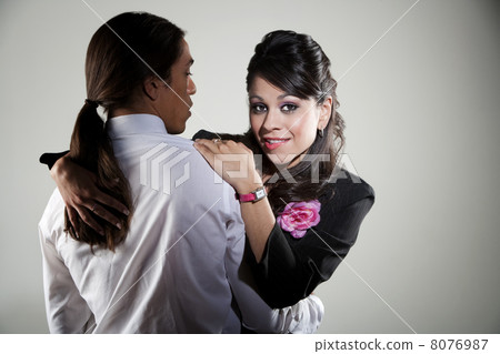 Mixed race professional man embracing Hispanic woman 8076987