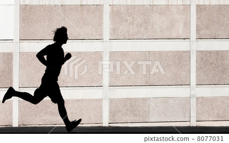 Physically fit man runs for exercise 8077031