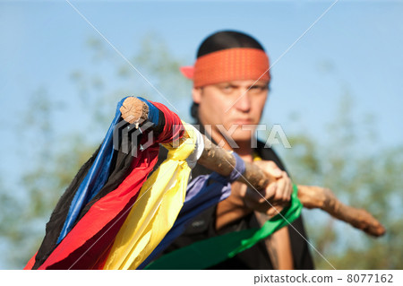Native American man with colorful flags 8077162