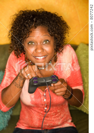 African-American woman plays video game 8077242