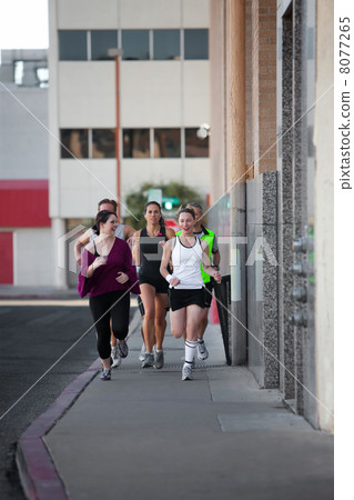 Group of friends runs downtown. Group of friends runs downtown. 8077265