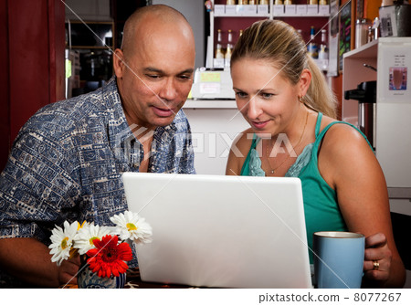 Couple in Coffee House with Laptop Computer Couple in Coffee House with Laptop Computer 8077267