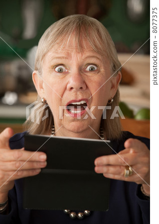 Senior woman with checkbook 8077375