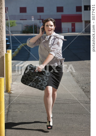 Working woman runs down street. Working woman runs down street. 8077431