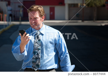 Upset, good-looking man angry with cell phone. 8077444