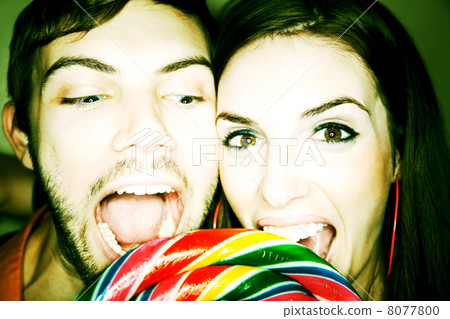 Couple Biting into Lollipop 8077800
