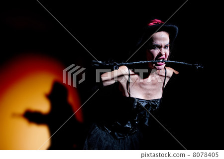 Lady in black carries whip 8078405
