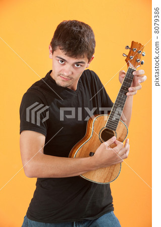 Serious Teen ukulele player Serious Teen ukulele player 8079386